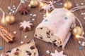 Traditional german christmas cake stollen with cookies and decoration on wooden table