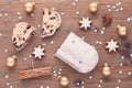 Traditional german christmas cake stollen with cookies and decoration on wooden table