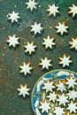 Traditional German Christmas Cookies Home Baked Glazed Cinnamon Stars with Nuts on Blue Plate Rusty Dark Green Background. Glitter