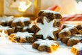 Traditional German Christmas Cookies Home Baked Glazed Cinnamon Stars with Nuts Sparkling Garland Lights Candle Candy Canes Royalty Free Stock Photo