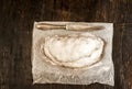 Traditional German Christmas fruit cake stollen on a dark background, around the fir branches and walnuts. View from above,copy s