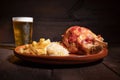 Traditional German cuisine roasted ham hock, sauerkraut and Beer, Oktoberfest background. Royalty Free Stock Photo