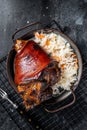 Traditional German cuisine Roasted pork knuckle Schweinshaxe with Sauerkraut. Black background. Top view Royalty Free Stock Photo