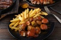Curry Sausage or currywurst with french fries. Royalty Free Stock Photo