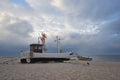 Traditional german fishing boat on the beach of Baltic sea in the sunset before storm. Picture taken in East Germany Royalty Free Stock Photo