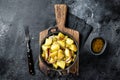 Traditional German Kartoffelsalat potato salad with cucumber, onion and mayonnaise in a skillet. Black background. Top