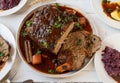 Traditional german meatloaf dinner with brown, sauce, potatoes and red cabbage