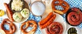 Traditional German Oktoberfest meal above view table scene on a white wood banner background