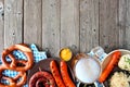 Traditional German Oktoberfest meal bottom border on a dark wood background