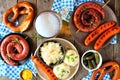 Traditional German Oktoberfest top down table scene over a dark wood background