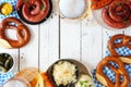 Traditional German Oktoberfest meal frame on a white wood background