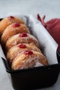 Traditional German Polish Donut with Raspberry Jam Dusted with Sugar. The traditional meal on Fat Thursday, the last day Royalty Free Stock Photo