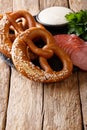 Traditional German pretzels, sausages and cream sauce close-up.