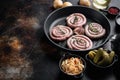 Traditional German Sausages with Mashed Potatoes and Sauerkraut in cast iron frying pan  on old dark rustic background  top view Royalty Free Stock Photo
