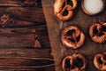 Traditional German Savory Lye Pretzel with Salt on Piece of Parchment Paper. Poster Banner for Bakery. Copy Space.Top Royalty Free Stock Photo