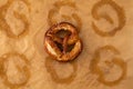 Traditional German Savory Lye Pretzel with Salt on Piece of Parchment Paper. Royalty Free Stock Photo