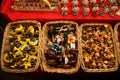 Traditional German wooden Christmas decorations in a wicker basket on a Christmas fair