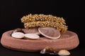 Traditional gold plated pearl bangles with seashells on sand Stone with black background. Traditional jewellery concept