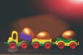 Traditional golden eggs in plastic colorful car toy or locomotive Royalty Free Stock Photo