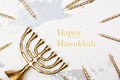 Traditional golden Hanukkah candleholder and candles on white ba