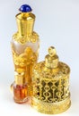 Traditional golden ornate flask of Arabian oud oil perfumes. Isolated white background