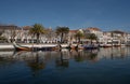 Traditional gondola boats decorated with tiles in river with historical colorful house facade in Aveiro Portugal Royalty Free Stock Photo