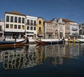 Traditional gondola boats decorated with tiles in river with historical colorful house facade in Aveiro Portugal