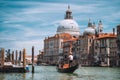 Traditional Gondola and gondolier on Canal Grande with Basilica di Santa Maria della Salute in the background in Venice Royalty Free Stock Photo