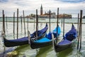 Traditional gondolas floating on the canal in Venice, in front of island San Giorgio Maggiore, Italy Royalty Free Stock Photo