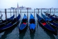 Traditional gondolas, tied up to the quay in Saint Mark`s square, at the pier in Grand Canal with San Giorgio Maggiore in the Royalty Free Stock Photo