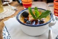 Typical french dessert creme brulee served with fruit and berries