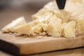 Traditional grana padano italian cheese on olive board
