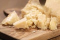 Traditional grana padano italian cheese on olive board