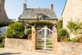 Traditional granite house and beautiful courtyard in Barfleur. Normandy, France Royalty Free Stock Photo