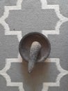 Traditional granite mortar and pestle on the carpet