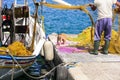 Authentic traditional Greece - scene with fisherman and cat avaiting the fish. Leros island, Agia Marina port