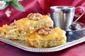 Traditional Greek baklava made with filo dough, sugar syrup and wallnuts on a metal tray with metal coffee cup on a Royalty Free Stock Photo