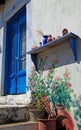 Traditional greek blue door and terracota ceramic jugs, Greece