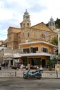 A traditional Greek Church and a cafe by the coast in Calymnos Island