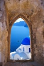 Traditional greek church through an old window in Santorini Royalty Free Stock Photo