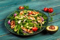 Traditional Greek cuisine of Cyprus. Salad with grilled Halloumi with tomatoes, avocado, and arugula. Vegan food. Diet menu. Flat Royalty Free Stock Photo