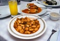 A traditional greek dish Fasolia - Giant beans on a tavern table, outdoors