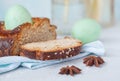 Traditional Greek Easter bread - tsoureki, sliced in Easter decoration with painted eggs and flowers. Royalty Free Stock Photo