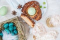 Traditional Greek Easter bread - tsoureki, sliced in Easter decorations with painted blue quail eggs in the nest and flowers. Top Royalty Free Stock Photo