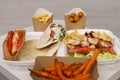 Traditional Greek fast food served on table in a cafe. Gyros sandwich, pita souvlaki, kalamaki and fries prepared for lunch in a Royalty Free Stock Photo