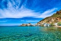 Traditional Greek fishermen village, blue sea, great sky, summer. Firopotamos, Milos island, Cyclades, Greece. Royalty Free Stock Photo