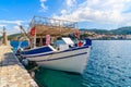 Traditional Greek fishing boat anchoring in Kokkari port, Samos island, Greece Royalty Free Stock Photo
