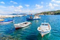 Traditional Greek fishing boats on blue sea in Kokkari bay, Samos island, Greece Royalty Free Stock Photo