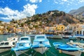 Traditional Greek fishing boats in harbour at Symi Town in the Dodecanese Greece Europe