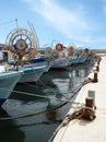 Traditional greek fishing boats with spools for lines moored in Paphos harbour in cyprus Royalty Free Stock Photo